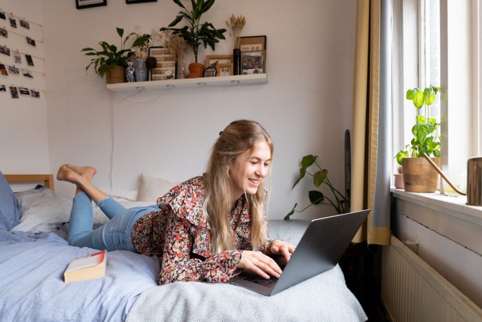 a student lying in a dorm room