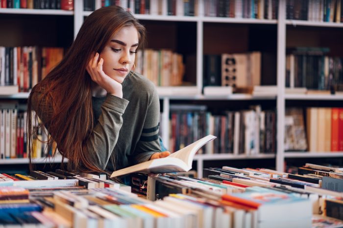 student reading in the library